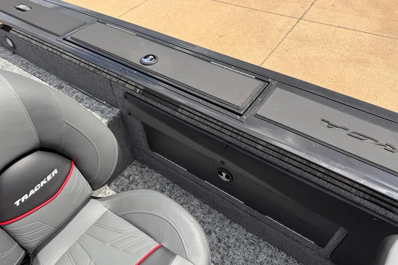 Slide: The Image of 2026 Tracker Targa V-19 WT boat interior with gray seating and storage compartments. - 12