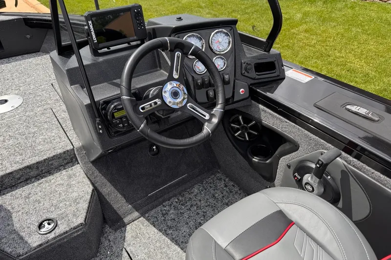 Slide: The Image of Interior of 2026 Tracker Targa V-19 WT boat with steering wheel and control panel. - 14