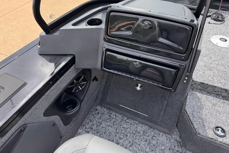 Slide: The Image of Interior view of 2026 Tracker Targa V-19 WT boat, featuring storage compartments and speaker. - 8