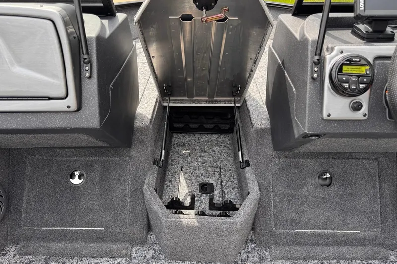 Slide: The Image of 2026 Tracker Pro Guide V-175 WT boat interior with open storage compartment and control panel. - 10