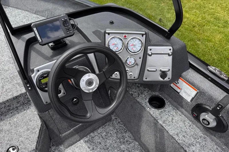 Slide: The Image of 2026 Tracker Pro Guide V-175 WT boat dashboard with steering wheel and gauges. - 11