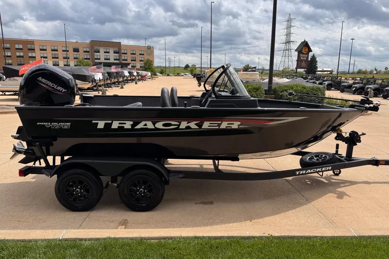 Slide: The Image of 2026 Tracker Pro Guide V-175 WT boat on trailer, displayed outdoors under cloudy sky. - 2