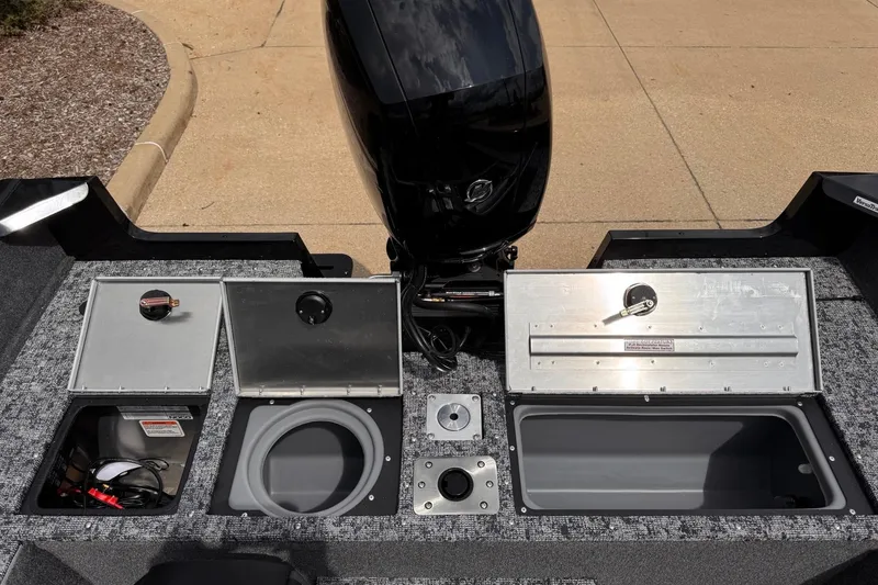 Slide: The Image of 2026 Tracker Pro Guide V-175 WT boat interior with storage compartments and motor. - 8