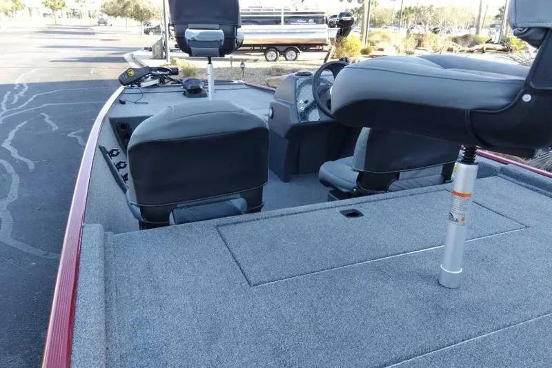 Slide: The Image of 2026 Tracker Bass Tracker Classic XL boat interior with seating and steering console. - 2