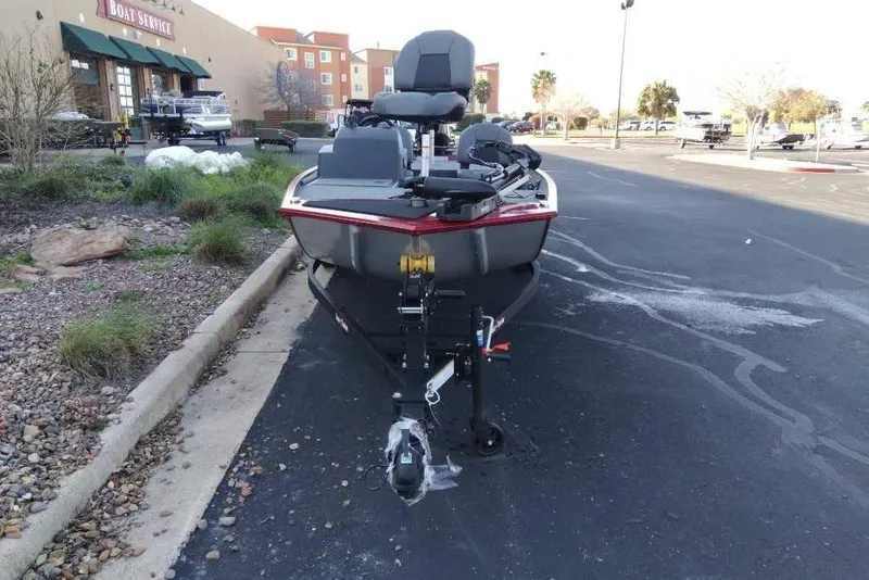Slide: The Image of 2026 Tracker Bass Tracker Classic XL boat parked near a boat service center. - 4