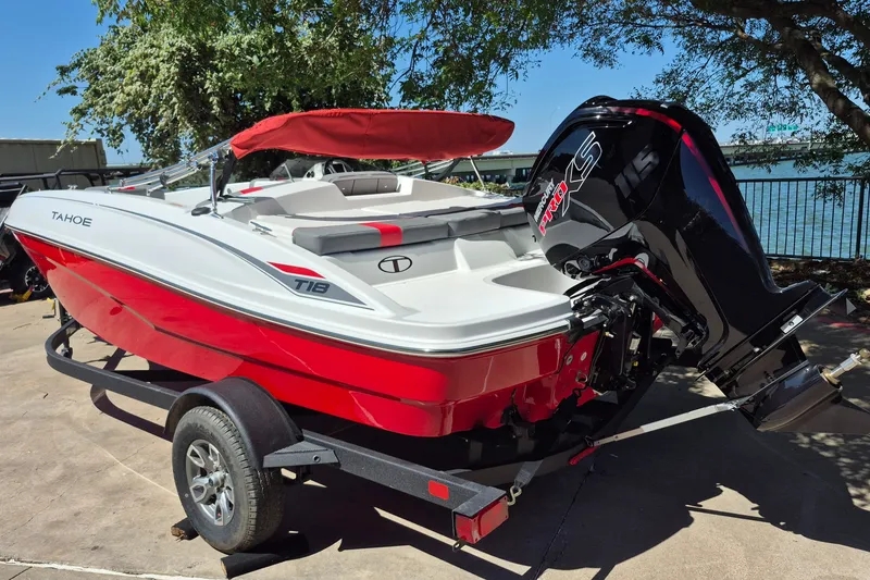 Slide: The Image of 2026 Tahoe T18 boat with red hull and powerful outboard motor on trailer. - 7