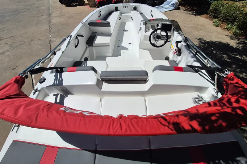 Slide: The Image of 2026 Tahoe T18 boat interior with red and gray seating, steering wheel, and controls. - 8