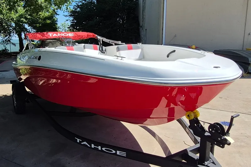 Slide: The Image of 2026 Tahoe T18 boat with red and white design on a trailer. - 3