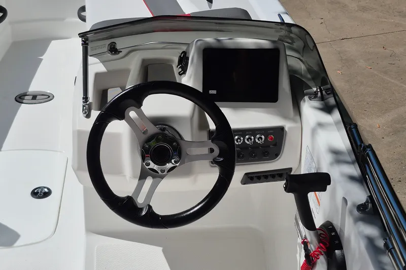 Slide: The Image of 2026 Tahoe T18 boat dashboard with steering wheel and control panel. - 9