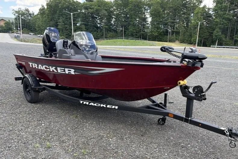 Slide: The Image of 2026 Tracker Super Guide V-16 SC boat on trailer, parked outdoors. - 3