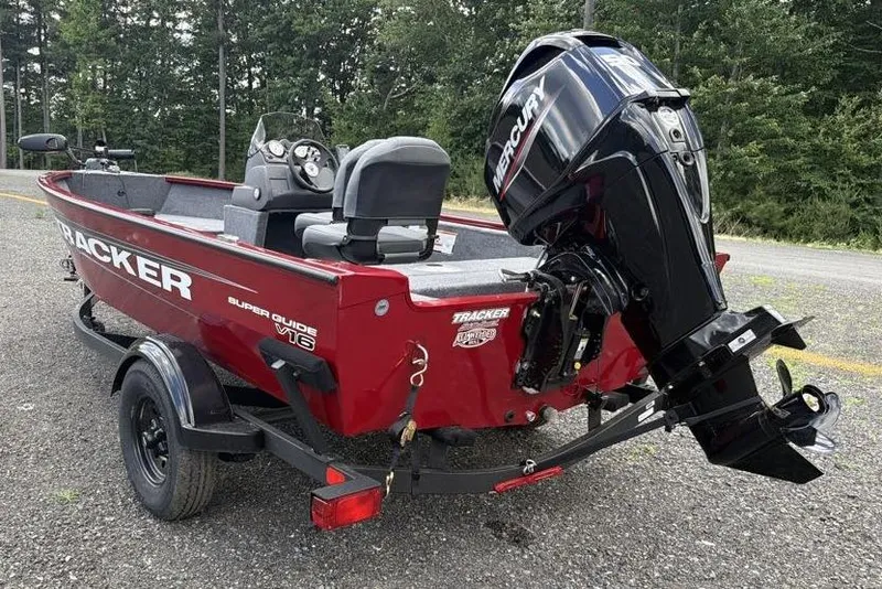 Slide: The Image of Red 2026 Tracker Super Guide V-16 SC boat with Mercury outboard motor on trailer. - 4