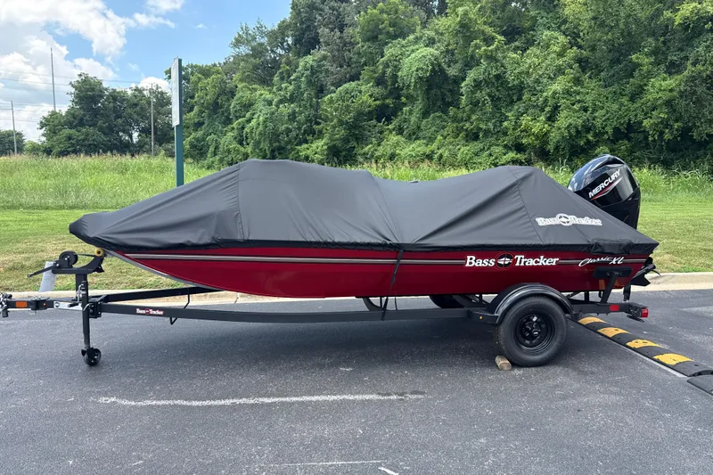 Slide: The Image of 2026 Tracker Bass Tracker Classic XL boat with cover on trailer, parked outdoors. - 4