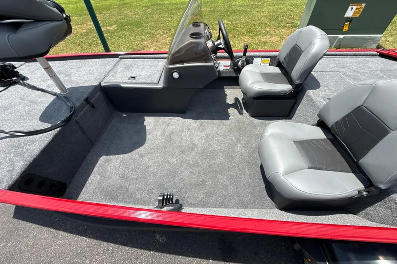 Slide: The Image of 2026 Tracker Bass Tracker Classic XL boat interior with gray seating and steering console. - 3