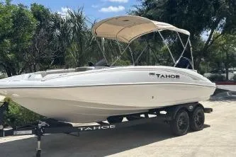 The Image of 2026 Tahoe 2150 boat on trailer, parked outdoors under a clear sky. - 0