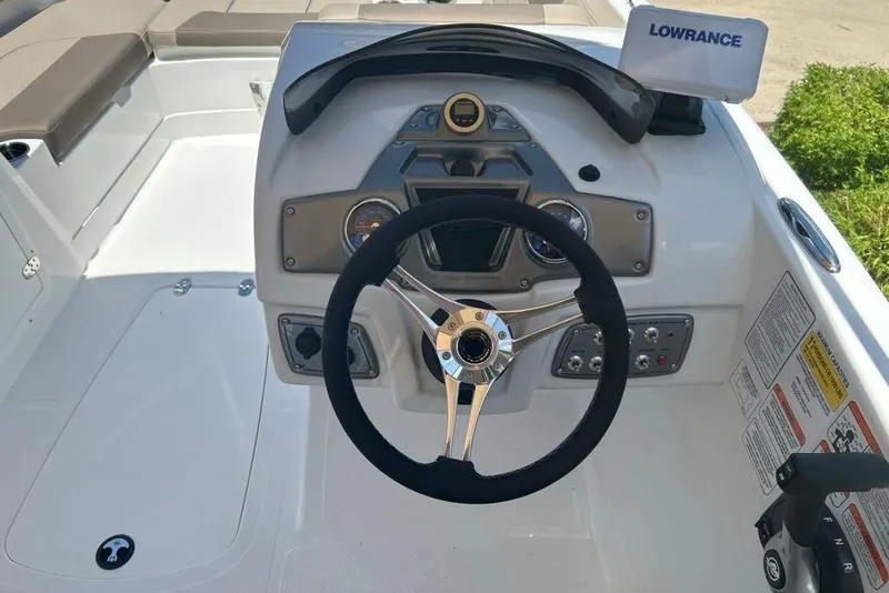 Slide: The Image of 2026 Tahoe 2150 boat dashboard with steering wheel and Lowrance navigation system. - 4