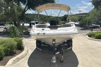 Slide: The Image of 2026 Tahoe 2150 boat on trailer, parked outdoors under sunny skies. - 1