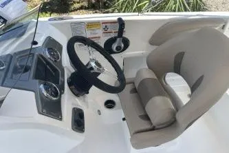 Slide: The Image of 2026 Tahoe 2150 boat cockpit with steering wheel and beige seating. - 3