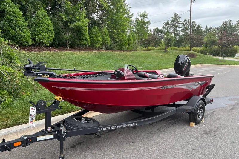 Slide: The Image of 2026 Ranger VS1665SC red fishing boat on trailer, parked outdoors. - 2