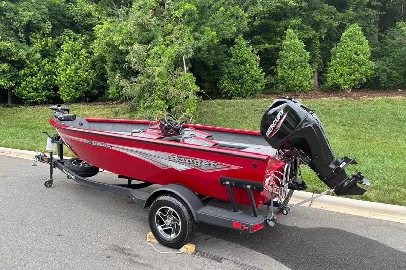 Slide: The Image of 2026 Ranger VS1665SC red fishing boat with Mercury outboard motor on trailer. - 3