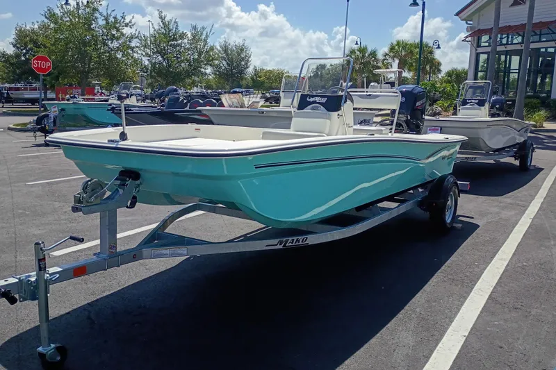 The Image of 2026 Mako Pro Skiff 17 CC boat on trailer in parking lot, sunny day. - 0