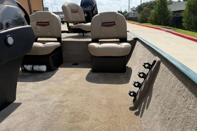 Slide: The Image of 2026 Tracker Bass Tracker Classic Limited boat interior with seating and rod holders. - 10