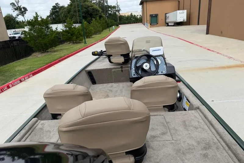 Slide: The Image of 2026 Tracker Bass Tracker Classic Limited boat interior with beige seats and steering wheel. - 6
