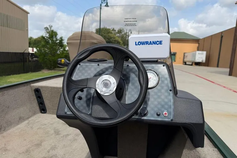 Slide: The Image of 2026 Tracker Bass Tracker Classic Limited boat dashboard with steering wheel and Lowrance device. - 3