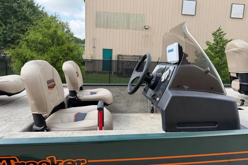 Slide: The Image of 2026 Tracker Bass Tracker Classic Limited boat interior with steering console and seating. - 5