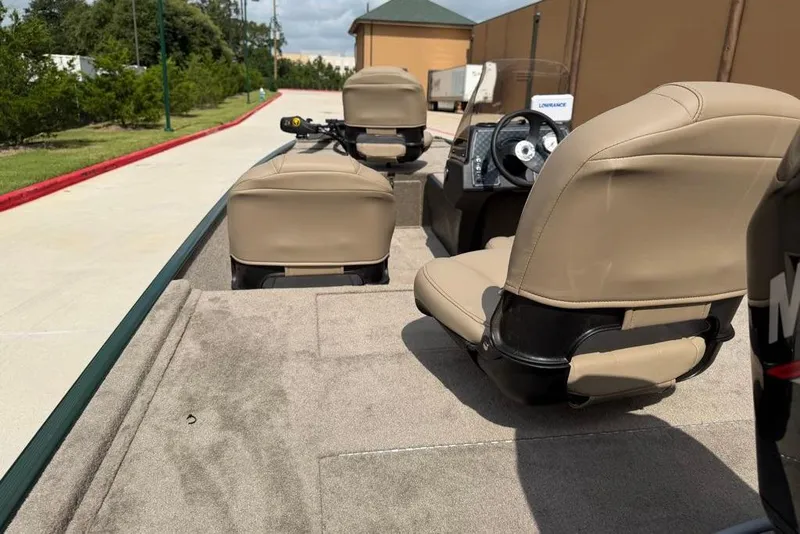 Slide: The Image of 2026 Tracker Bass Tracker Classic Limited boat interior with beige seats and steering console. - 9