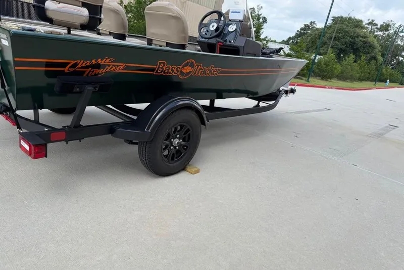Slide: The Image of 2026 Tracker Bass Tracker Classic Limited boat on trailer in parking lot. - 14