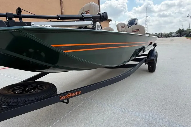 Slide: The Image of 2026 Tracker Bass Tracker Classic Limited boat on trailer, green with orange stripes. - 11