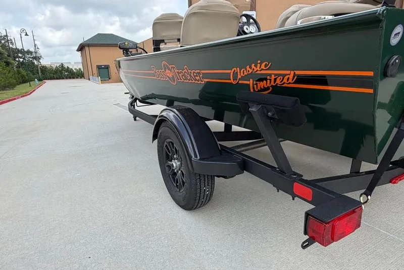 Slide: The Image of 2026 Tracker Bass Tracker Classic Limited boat on trailer, parked outdoors. - 12