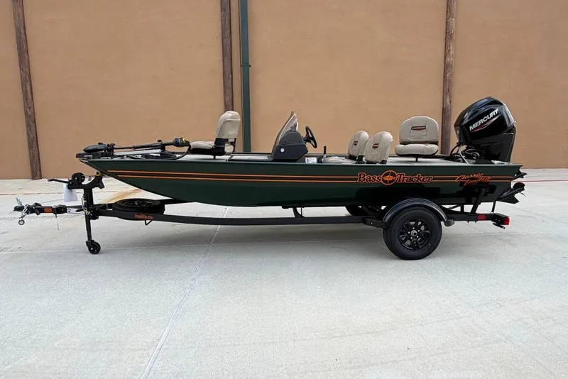 The Image of 2026 Tracker Bass Tracker Classic Limited fishing boat on trailer, side view. - 0