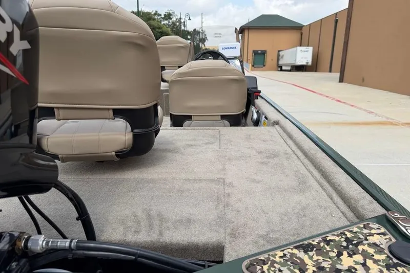 Slide: The Image of 2026 Tracker Bass Tracker Classic Limited boat interior with beige seats and camouflage accents. - 7