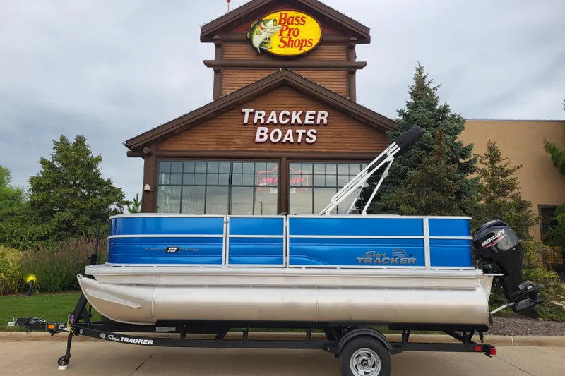 The Image of 2026 Sun Tracker Party Barge 18 DLX pontoon boat outside Bass Pro Shops Tracker Boats. - 0