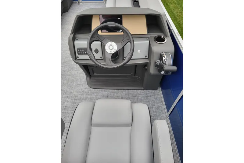 Slide: The Image of 2026 Sun Tracker Party Barge 18 DLX helm with steering wheel and controls. - 10