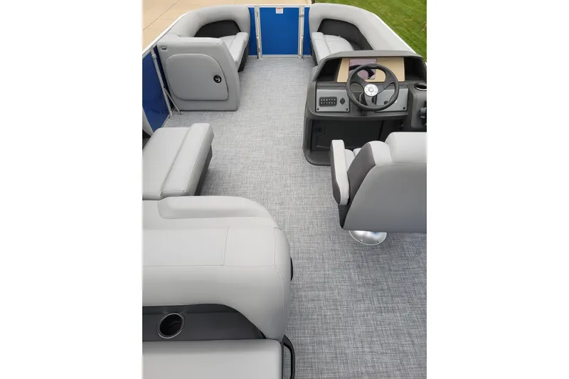 Slide: The Image of 2026 Sun Tracker Party Barge 18 DLX interior with gray seating and steering console. - 2