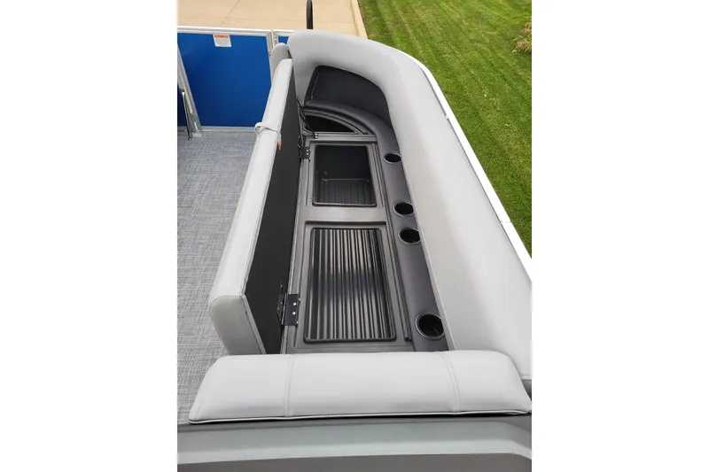 Slide: The Image of 2026 Sun Tracker Party Barge 18 DLX interior seating with storage and cup holders. - 6