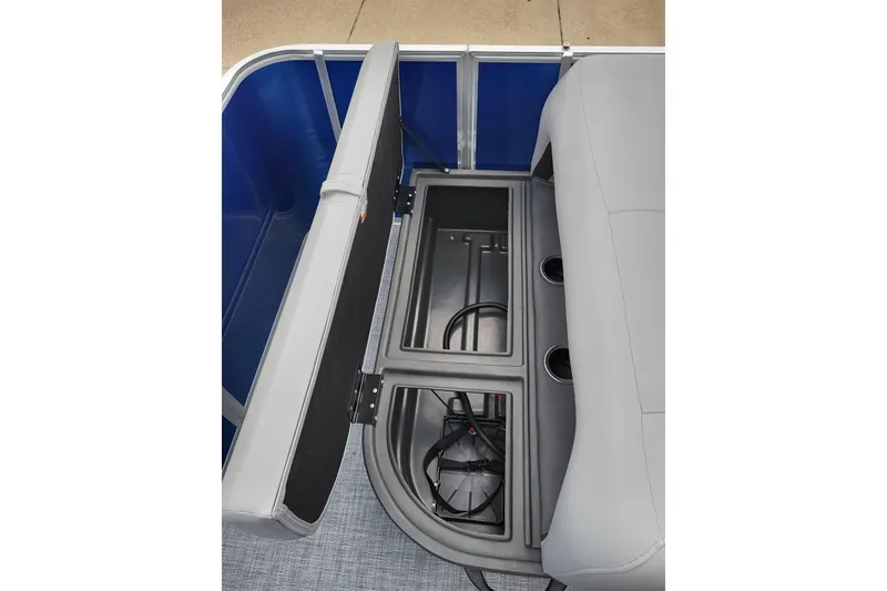 Slide: The Image of 2026 Sun Tracker Party Barge 18 DLX storage compartment with gray seating and cup holders. - 9