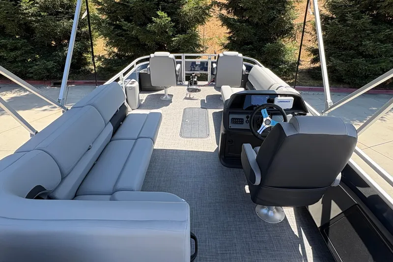 Slide: The Image of 2026 Sun Tracker Sportfish 24 XP3 pontoon boat interior with plush seating and modern helm. - 11