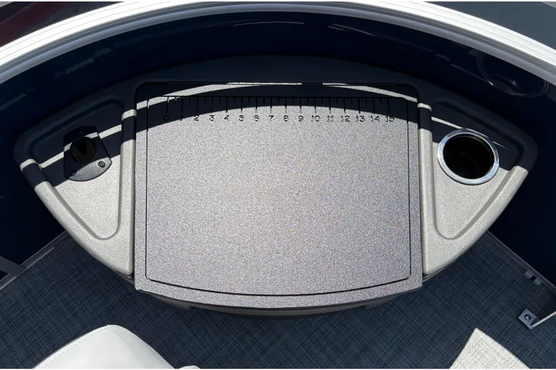 Slide: The Image of 2026 Sun Tracker Sportfish 24 XP3 boat console with ruler and cup holders. - 20