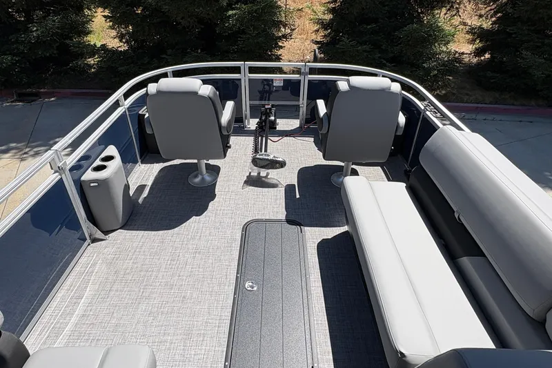 Slide: The Image of 2026 Sun Tracker Sportfish 24 XP3 boat interior with seating and fishing rod holders. - 13