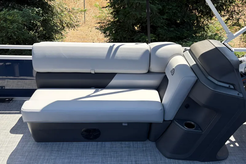 Slide: The Image of 2026 Sun Tracker Sportfish 24 XP3 boat interior with cushioned seating and console. - 17