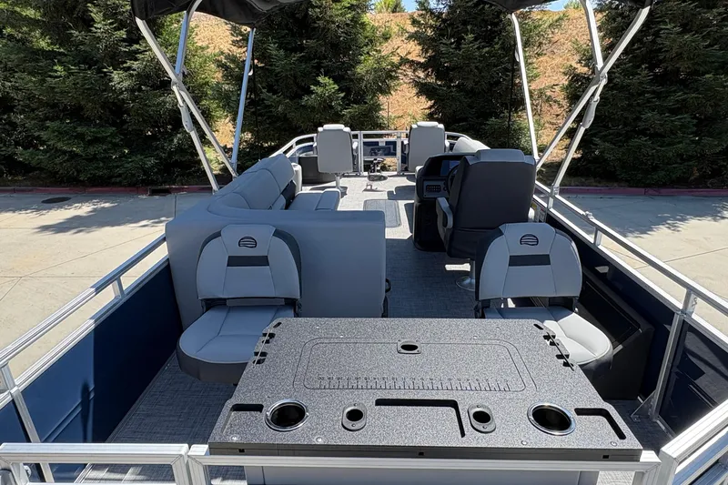 Slide: The Image of 2026 Sun Tracker Sportfish 24 XP3 pontoon boat interior with seating and helm. - 16