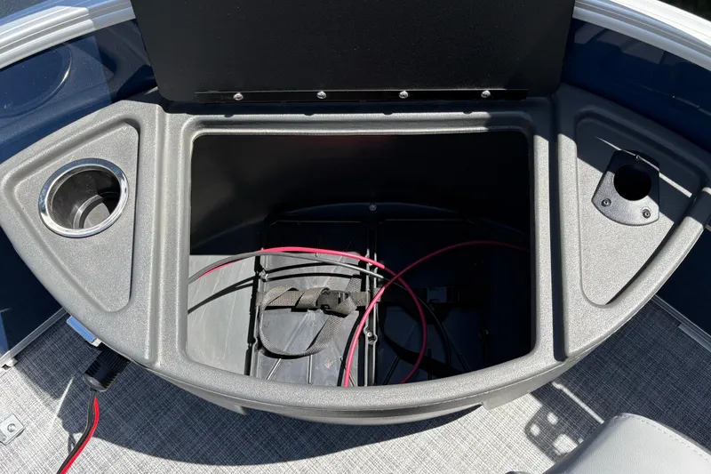 Slide: The Image of Open storage compartment on 2026 Sun Tracker Sportfish 24 XP3 boat, featuring cup holders. - 25