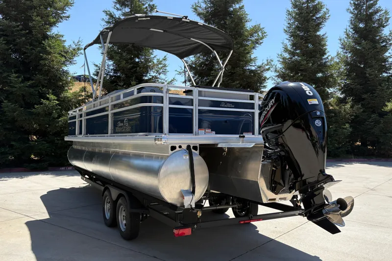 Slide: The Image of 2026 Sun Tracker Sportfish 24 XP3 pontoon boat with Mercury outboard motor on trailer. - 6