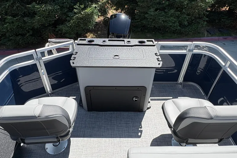 Slide: The Image of 2026 Sun Tracker Sportfish 24 XP3 boat interior with seating and fishing station. - 12
