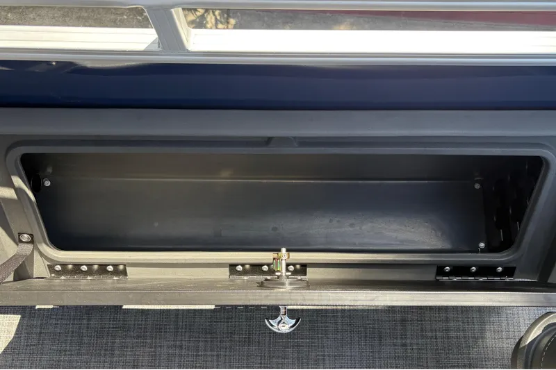 Slide: The Image of Storage compartment of 2026 Sun Tracker Sportfish 24 XP3 boat, open and empty. - 32