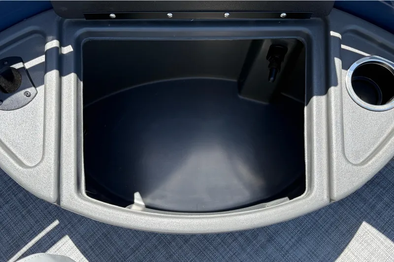 Slide: The Image of 2026 Sun Tracker Sportfish 24 XP3 boat storage compartment with cup holder and sleek design. - 26