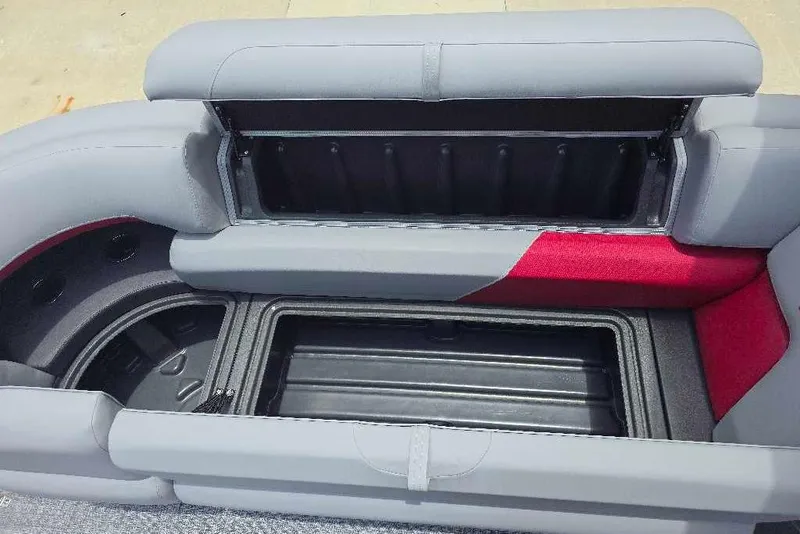 Slide: The Image of 2026 Sun Tracker Party Barge 20 DLX seating with open storage compartments. - 8